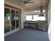 Outdoor kitchen with stainless steel BBQ grill and sliding doors leading indoors at 5331 71St N Way, St Petersburg, FL 33709