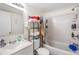 Clean and functional bathroom with a shower-tub combo, white fixtures, and ample storage at 5820 N Church Ave # 247, Tampa, FL 33614