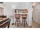 Charming dining area featuring wooden barstools and view into adjacent kitchen at 5820 N Church Ave # 247, Tampa, FL 33614