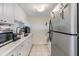 Well-maintained kitchen with ample counter space, white cabinets, and stainless steel refrigerator at 5820 N Church Ave # 247, Tampa, FL 33614