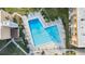 Aerial view of a large community pool with lounge chairs and clear blue water at 5820 N Church Ave # 247, Tampa, FL 33614