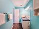 Teal bathroom with white vanity, and dark wood-look floors at 6025 Shore S Blvd # 504, Gulfport, FL 33707