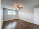 Bright bedroom with dark laminate floors and ceiling fan at 6025 Shore S Blvd # 504, Gulfport, FL 33707