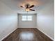 Simple bedroom with ceiling fan and dark wood-look flooring at 6025 Shore S Blvd # 504, Gulfport, FL 33707