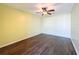 Bright bedroom with ceiling fan and dark wood-look flooring at 6025 Shore S Blvd # 504, Gulfport, FL 33707