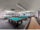 Well-lit game room with billiard tables and shuffleboard at 6025 Shore S Blvd # 504, Gulfport, FL 33707