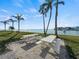 Community patio area with white picnic tables and waterfront views at 6025 Shore S Blvd # 504, Gulfport, FL 33707