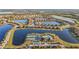 An aerial view of the neighborhood featuring single-Gathering homes with red tile roofs surrounding a lake and community amenities at 6467 Willowshire Way, Bradenton, FL 34212