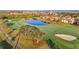 Picturesque aerial view of a golf course with a pond, tree, sand trap and surrounding residences at 6467 Willowshire Way, Bradenton, FL 34212