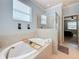 Bathroom featuring a soaking tub, and a glass-enclosed shower at 6467 Willowshire Way, Bradenton, FL 34212