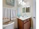 This bathroom has a vanity with storage, a large mirror, and a seashell themed decor at 6467 Willowshire Way, Bradenton, FL 34212