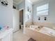 Inviting bathroom featuring a soaking tub, a window, and natural light at 6467 Willowshire Way, Bradenton, FL 34212