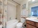 This bathroom has a shower with a tile surround, a vanity with storage, and a decorative shower curtain at 6467 Willowshire Way, Bradenton, FL 34212