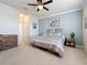 Spacious bedroom featuring plush carpet, stylish furnishings, and a ceiling fan at 6467 Willowshire Way, Bradenton, FL 34212