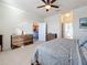 Relaxing bedroom with plush carpet, ceiling fan, and an ensuite bathroom at 6467 Willowshire Way, Bradenton, FL 34212