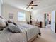 Comfortable bedroom with carpet, a ceiling fan, and a walk-out slider to the lanai at 6467 Willowshire Way, Bradenton, FL 34212