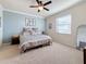 Bright bedroom with a large window, ceiling fan, and neutral decor at 6467 Willowshire Way, Bradenton, FL 34212