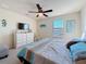 This bedroom features coastal themed decor and has a ceiling fan, dresser, and sunny window at 6467 Willowshire Way, Bradenton, FL 34212