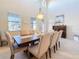 Bright dining room featuring a large table with neutral tones, and plenty of natural light at 6467 Willowshire Way, Bradenton, FL 34212