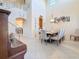 Elegant dining room with high ceilings, neutral colors, and a view of the staircase at 6467 Willowshire Way, Bradenton, FL 34212