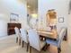 Formal dining room featuring a large table with seating for six and views of the staircase at 6467 Willowshire Way, Bradenton, FL 34212