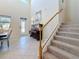 Elegant foyer featuring a piano, staircase, and a decorative glass front door at 6467 Willowshire Way, Bradenton, FL 34212