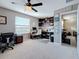 Bright flex room featuring a built-in desk, shelving, and a window for natural light and air circulation at 6467 Willowshire Way, Bradenton, FL 34212