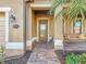 Welcoming front porch featuring a swing, brick pathway, and decorative door with sidelights at 6467 Willowshire Way, Bradenton, FL 34212