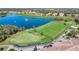 Aerial view of the golf course with golf carts and surrounding amenities in the River Strand community at 6467 Willowshire Way, Bradenton, FL 34212