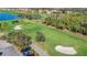 An aerial view of the golf course with well-maintained greens, sand traps and a view of the surrounding community at 6467 Willowshire Way, Bradenton, FL 34212