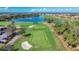 Scenic aerial view of the golf course, with a serene lake and lush greenery at the River Strand community at 6467 Willowshire Way, Bradenton, FL 34212