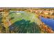 Aerial view of a lush green golf course with sand traps and manicured fairways next to upscale residences at 6467 Willowshire Way, Bradenton, FL 34212