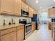 Bright kitchen showcasing stainless steel appliances, granite countertops, and ample cabinet space at 6467 Willowshire Way, Bradenton, FL 34212