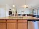 Kitchen island with stainless steel dishwasher and sink; an open floor plan concept to the Gathering room at 6467 Willowshire Way, Bradenton, FL 34212