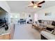 Spacious living room on the upper floor featuring a piano and views of the upper floor railing at 6467 Willowshire Way, Bradenton, FL 34212