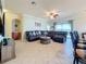 Living room showcases a large sofa, tiled floors, and an open floor plan at 6467 Willowshire Way, Bradenton, FL 34212