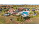 Aerial view of the community clubhouse and pool area, featuring lush landscaping and recreational amenities at 6467 Willowshire Way, Bradenton, FL 34212