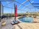 Screened-in pool area with a brick paver deck, and a partial outdoor dining set at 6467 Willowshire Way, Bradenton, FL 34212