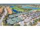 Aerial view of the tennis courts, featuring well-maintained surfaces surrounded by lush greenery and parking in River Strand at 6467 Willowshire Way, Bradenton, FL 34212