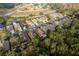 Aerial view of a residential community nestled among trees and a pond at 6538 Green Acres Blvd, New Port Richey, FL 34655