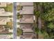 Aerial view of a residential area with houses and a wooded area at 6538 Green Acres Blvd, New Port Richey, FL 34655