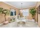 Formal dining room with a glass-top table and white chairs at 6538 Green Acres Blvd, New Port Richey, FL 34655