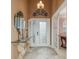 Elegant entryway with glass-paned door and a glass-top console table at 6538 Green Acres Blvd, New Port Richey, FL 34655