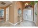 Bright entryway with a glass-top console table and tiled floors at 6538 Green Acres Blvd, New Port Richey, FL 34655