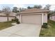 Two-car garage with light tan walls and a concrete driveway at 6538 Green Acres Blvd, New Port Richey, FL 34655