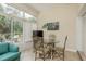 Sunroom dining area with glass table and chairs, offering natural light at 6538 Green Acres Blvd, New Port Richey, FL 34655