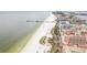 Picturesque coastal view featuring a sandy beach, road, and multiple buildings at 684 Bayway Blvd, Clearwater, FL 33767