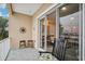 Relaxing balcony featuring tiled floors, seating, and sliding glass doors to the interior living space at 684 Bayway Blvd, Clearwater, FL 33767