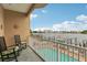 Balcony view featuring outdoor furniture overlooking a pool and canal at 684 Bayway Blvd, Clearwater, FL 33767