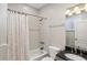 Tiled bathroom with shower-tub combo and granite vanity at 684 Bayway Blvd, Clearwater, FL 33767